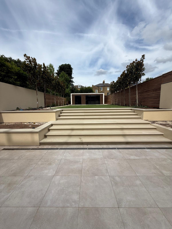 Monocouche render in ivory to garden walls and bbq area at Clapham, London. Rowland & Wyllie Plastering