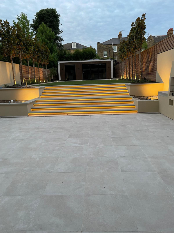 Monocouche render in ivory to garden walls and bbq area at Clapham, London. Rowland & Wyllie Plastering